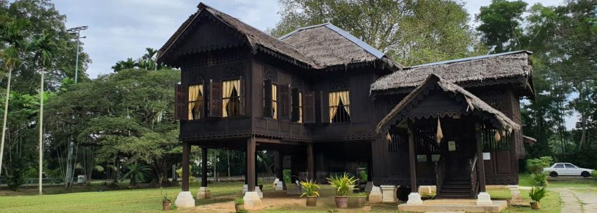 Traditional Malay wooden bungalow in a large compound